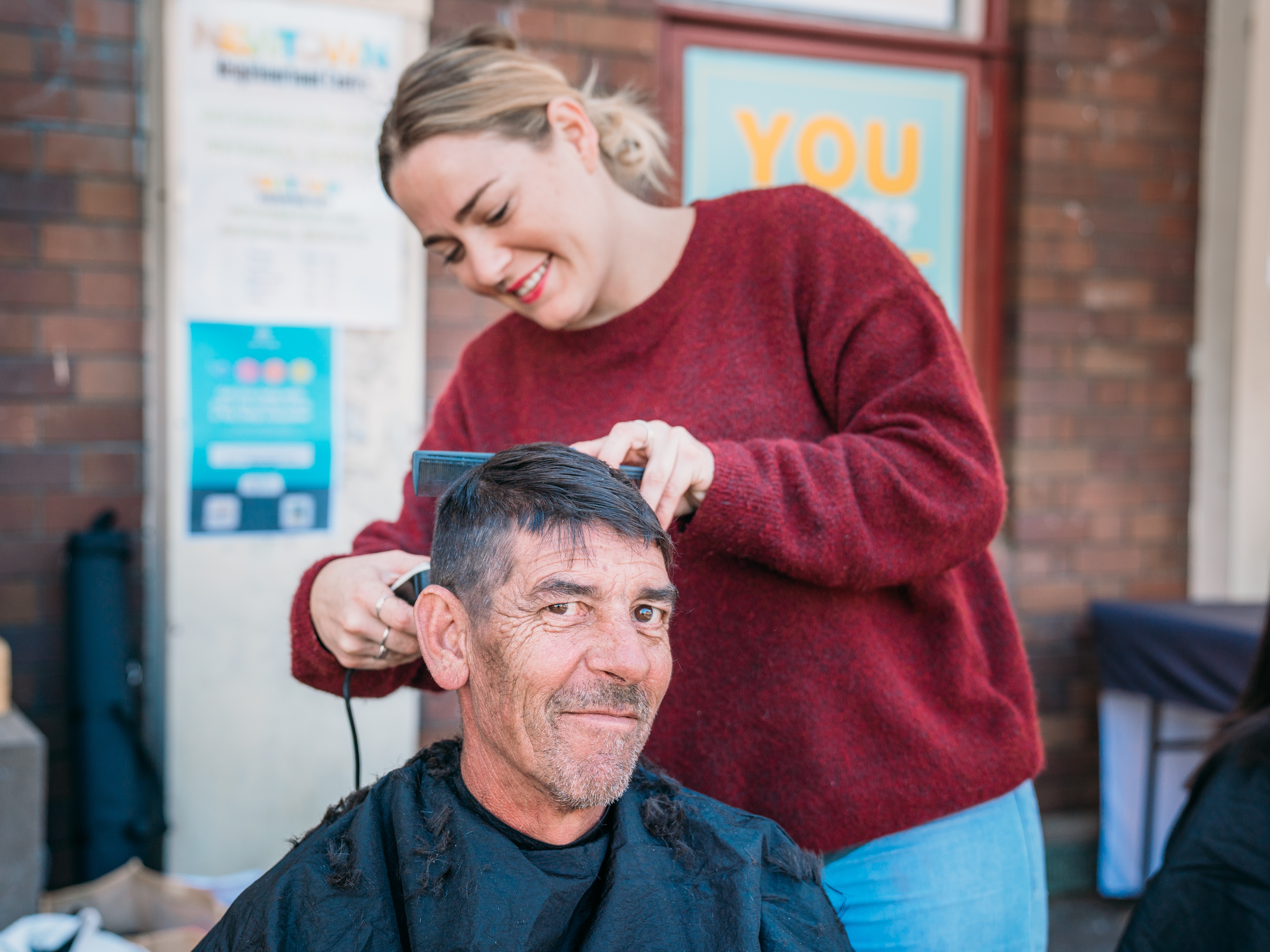 Mietta giving customer a haircut